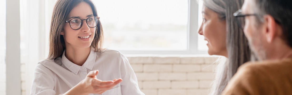 Mature couple speaking with their financial advisor.